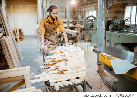 Carpentry worker works at the warehouse 73029147