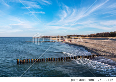 Groynes on shore of the Baltic sea in Graal-Mueritz, Germany Groynes on shore of the Baltic sea in Graal-Mueritz, Germany 73029446