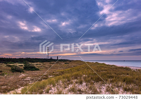 Lighthouse and radio tower on shore of the Baltic Sea 73029448