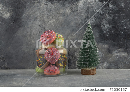 Colorful sweet doughnuts with Christmas tree toy Colorful sweet doughnuts with Christmas tree toy 73030167