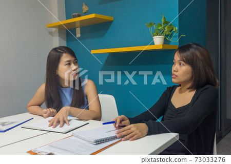 Office women talking about work in office Office women talking about work in office 73033276