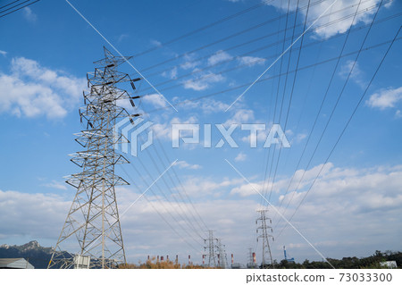 high voltage post.High-voltage tower on blue sky and clouds background 73033300