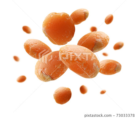 Red lentils levitate on a white background Red lentils levitate on a white background 73033378