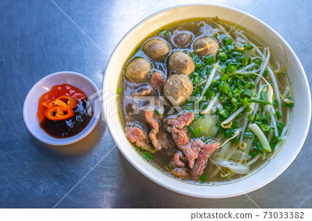 Vietnam flavored Pho bowl- beef meat noodles and vegetables Vietnam flavored Pho bowl- beef meat noodles and vegetables 73033382