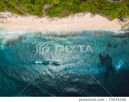 Wild tropical sandy beach and ocean with waves at Bali. Aerial view 73034286