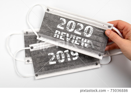 2020 Review. Business, health and education concept. Face masks on a white background 2020 Review. Business, health and education concept. Face masks on a white background 73036886