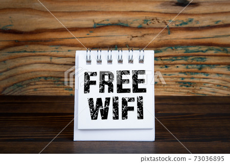 Free wifi. Mobile communications, technology and costs concept. White notebook Free wifi. Mobile communications, technology and costs concept. White notebook 73036895