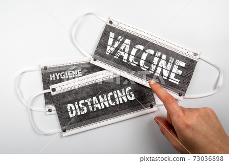 Vaccine, Distancing and Hygiene concept. Face masks on a white background Vaccine, Distancing and Hygiene concept. Face masks on a white background 73036898