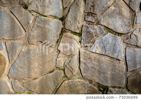Background of stone wall texture. The surface of the stones is brown Background of stone wall texture. The surface of the stones is brown 73036899