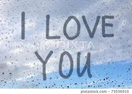 Writing i love you on steamy window. Valentine's day background Writing i love you on steamy window. Valentine's day background 73036910