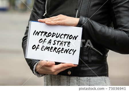 Introduction of a state of emergency. Notebook in a woman's hand 73036941