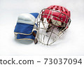 Hockey gloves,helmet and puck lay a white background isolated 73037094