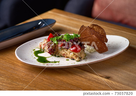 Eggplant caviar with cheese mousse on the table, serving in a restaurant, menu food concept. copy space. Eggplant caviar with cheese mousse on the table, serving in a restaurant, menu food concept. copy space. 73037820