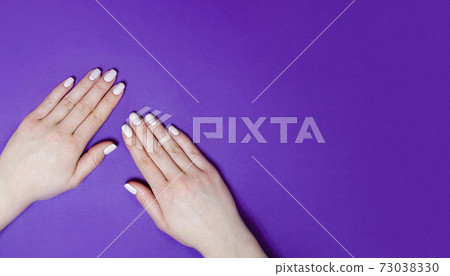 Female manicure on a bright background. Purple Female manicure on a bright background. Purple 73038330