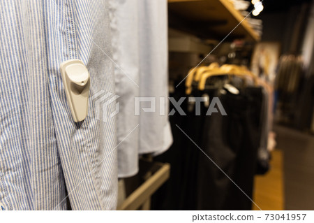 Close-up of RFID theft security tag attached onto apparels in clothing shop Close-up of RFID theft security tag attached onto apparels in clothing shop 73041957