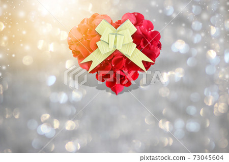 Rose petals heart shape with golden gift bow on background bokeh 73045604