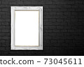 white frame on black brick wall 73045611