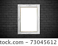 white frame on black brick wall 73045612