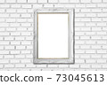 white frame on white brick wall 73045613