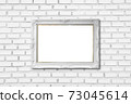 white frame on white brick wall 73045614