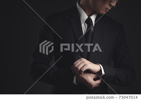Close up shot of businessman in black suit. 73047014
