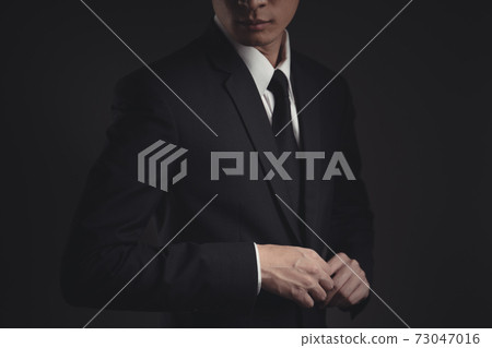 Close up shot of businessman in black suit. Close up shot of businessman in black suit. 73047016