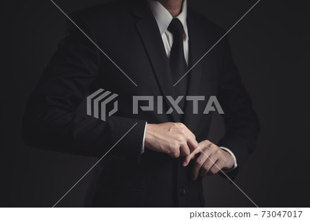 Close up shot of businessman in black suit. Close up shot of businessman in black suit. 73047017