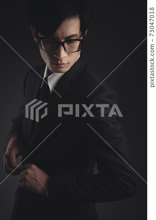 Close up shot of businessman in black suit. Close up shot of businessman in black suit. 73047018