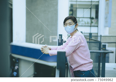 asian woman wearing protection mask standing bulding outside asian woman wearing protection mask standing bulding outside 73049962