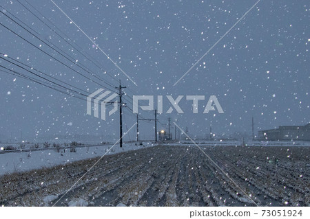 A train running in the snow in the night sky in the new year of 2021 73051924
