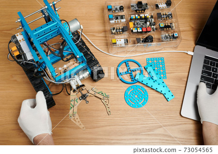 Kid working with robot Kid working with robot 73054565