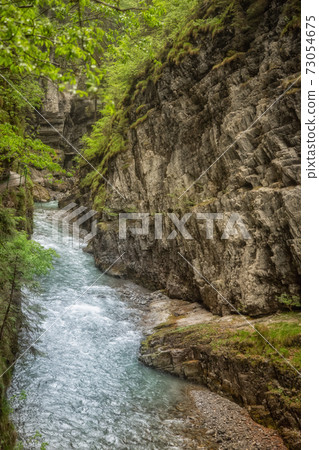 A wild river in the midst of impressive nature A wild river in the midst of impressive nature 73054675