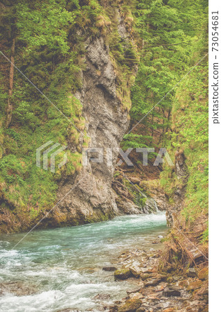 A wild river in the midst of impressive nature A wild river in the midst of impressive nature 73054681