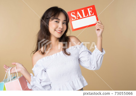 Beautiful female model promoting a sale promotion Beautiful female model promoting a sale promotion 73055066