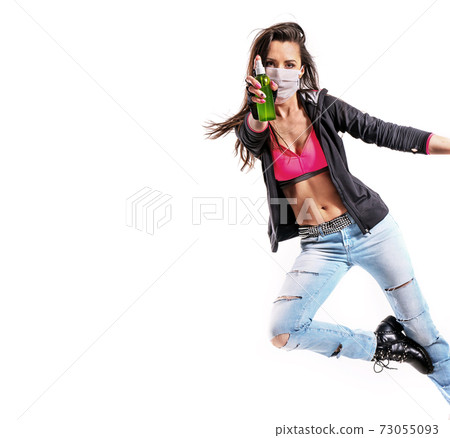 Young dancer splashing an antibacterial liquid 73055093