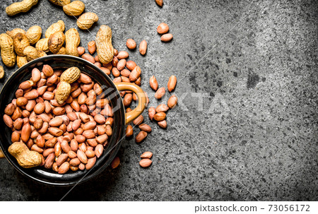 Peanuts in a bowl. 73056172