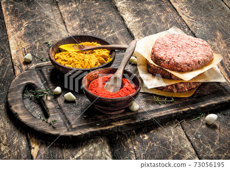 Raw burger with spices and herbs. Raw burger with spices and herbs. 73056195