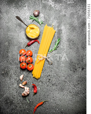 Spaghetti with tomatoes, mustard sauce and spices. Spaghetti with tomatoes, mustard sauce and spices. 73056331