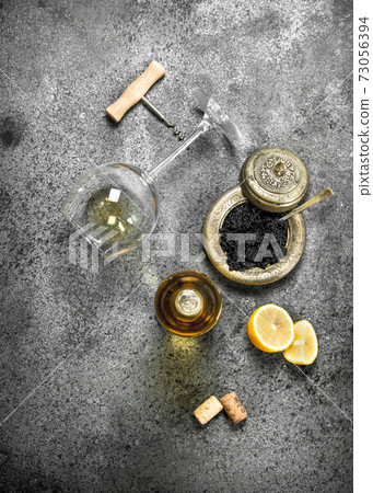 Black caviar with a glass of white wine. 73056394