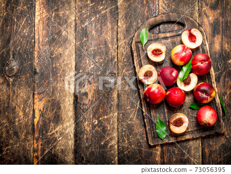 Fresh peaches with green leaves. Fresh peaches with green leaves. 73056395