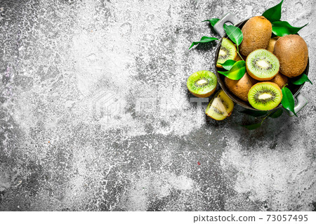 Fresh kiwi in a bowl . Fresh kiwi in a bowl . 73057495