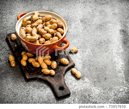 Peanuts in a bowl. 73057650