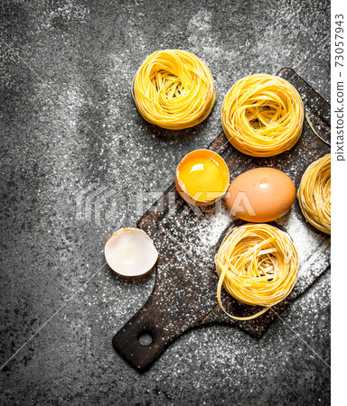 Pasta background. Cooking homemade pasta with egg and flour. Pasta background. Cooking homemade pasta with egg and flour. 73057943