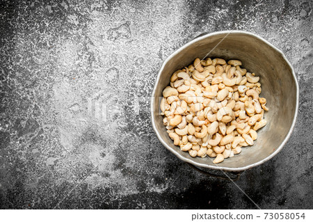 Cashews in the old bucket. 73058054