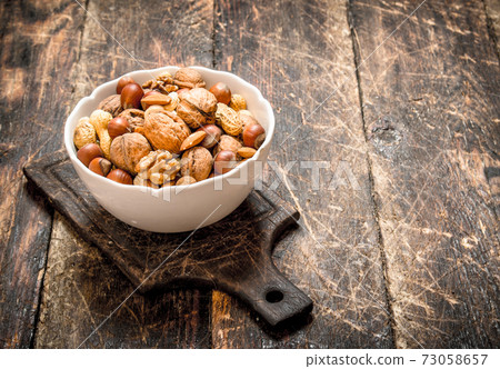 Different nuts in a bowl. Different nuts in a bowl. 73058657
