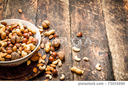 Different nuts in a bowl. Different nuts in a bowl. 73058890