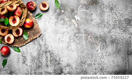 Peaches in the basket. 73059227