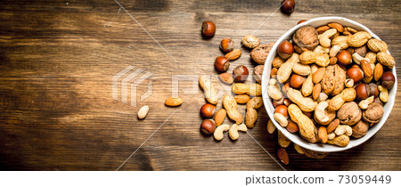 Different nuts in a bowl. Different nuts in a bowl. 73059449