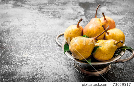 Ripe pears in a bowl. 73059517