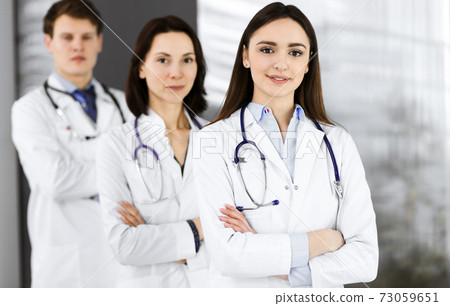 Young Female Nurse With Folded Arms Standing In Hospital Stock